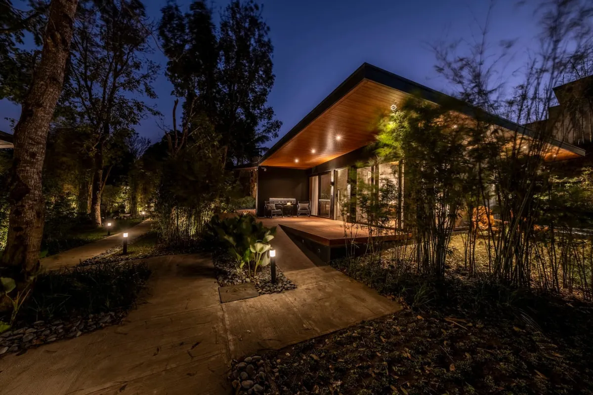 Cabin exterior at night with garden pathway